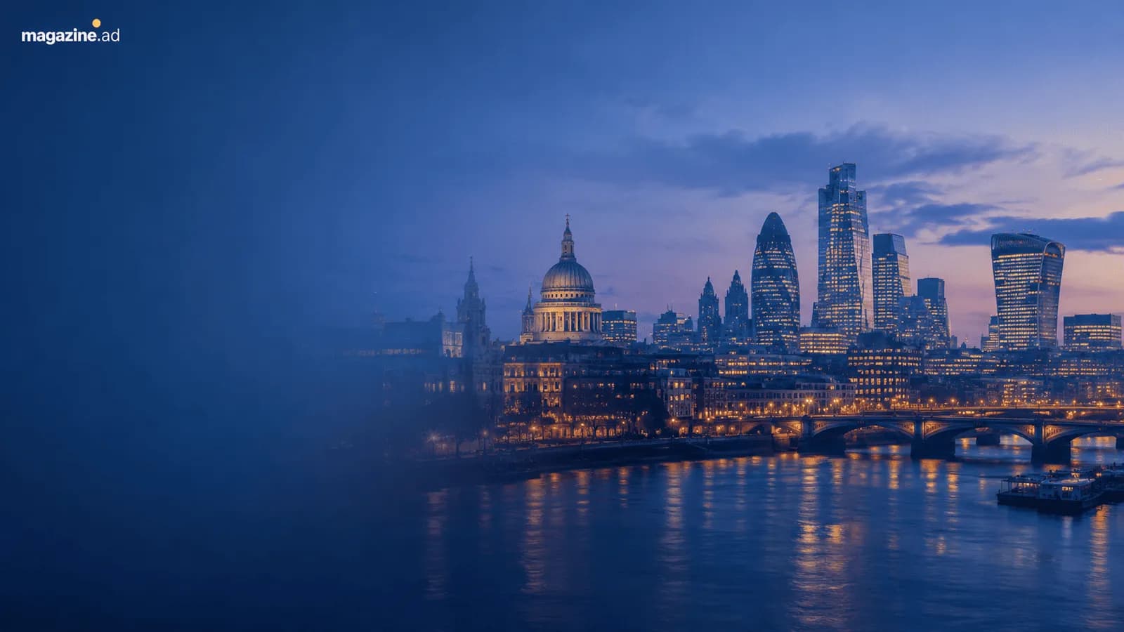 An evening cityscape shows St. Paul's Cathedral and several modern skyscrapers illuminated, with a river and bridges in the foreground reflecting the city lights.